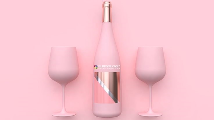 wine bottle and glasses on a pink background