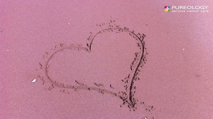 heart drawn in pink sand background